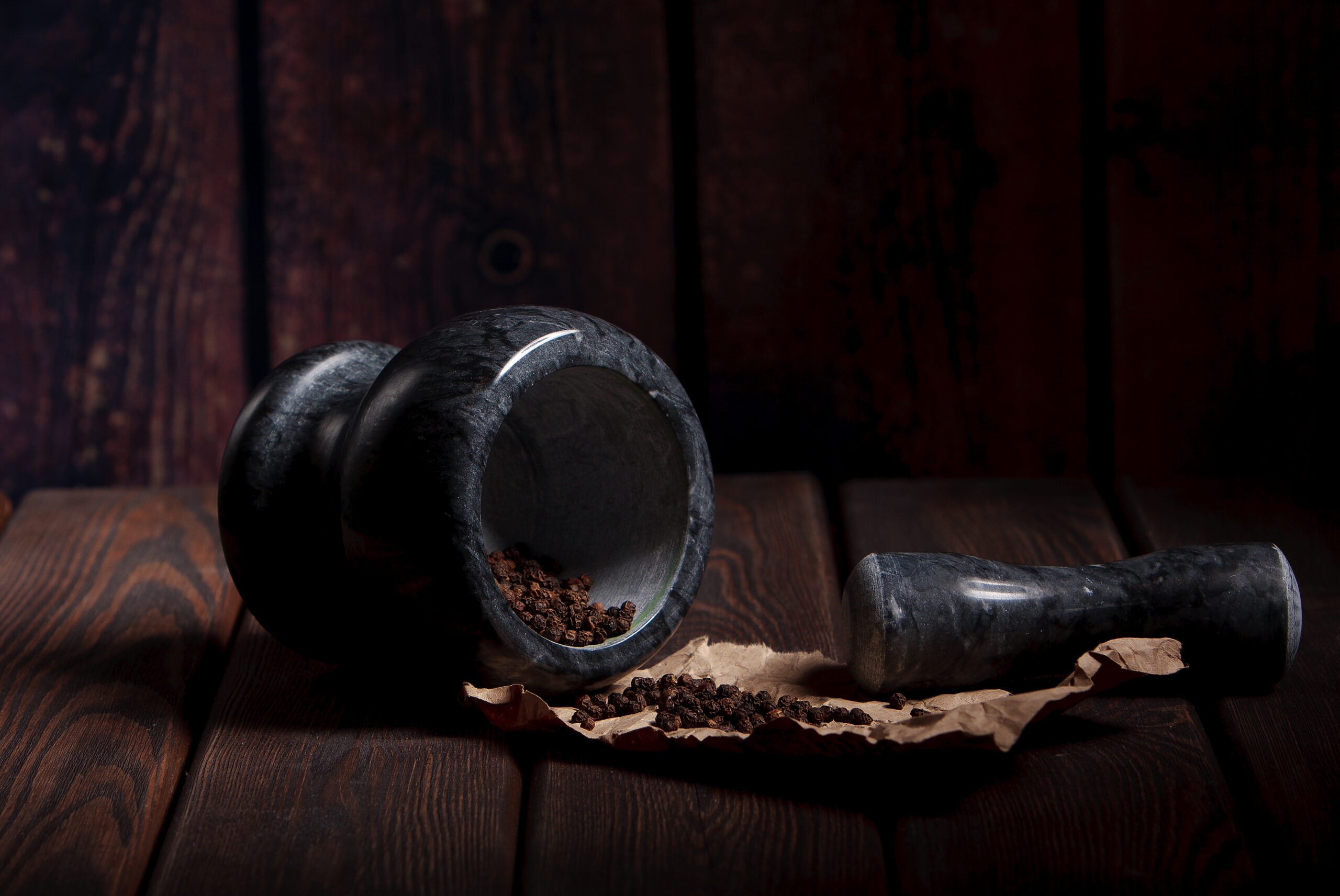 Mortar petle spices on vintage wooden table